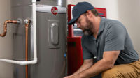 April 2024 Guest Editorial Evan Heidenrich. Plumber working on water heater.