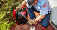 Worker using the Milwaukee Tool SWITCH PACK drain cleaner