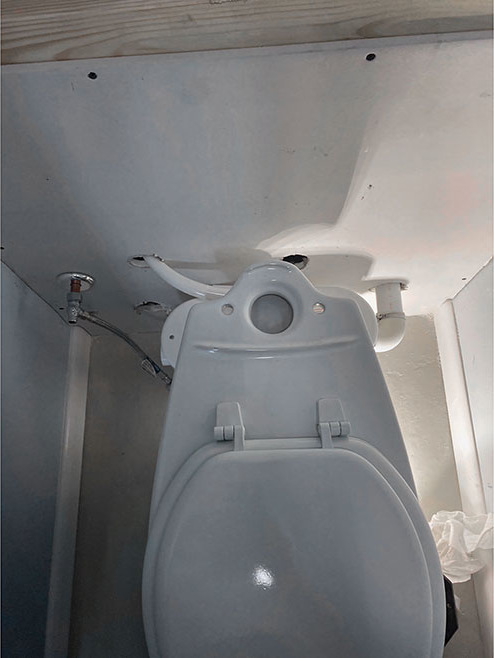 Saniflo CS Cariola In-Law Suit. View of Saniflo’s rear-discharge toilet from the top as well as the plumbing set up before connecting the macerator pump.