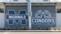 Kathleen MacDonald High School name and logo, Condors logo on wall.