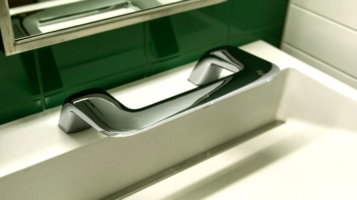 Close-up of the WashBar, a touch-free soap, water and hand dryer in one single chrome-plated component.