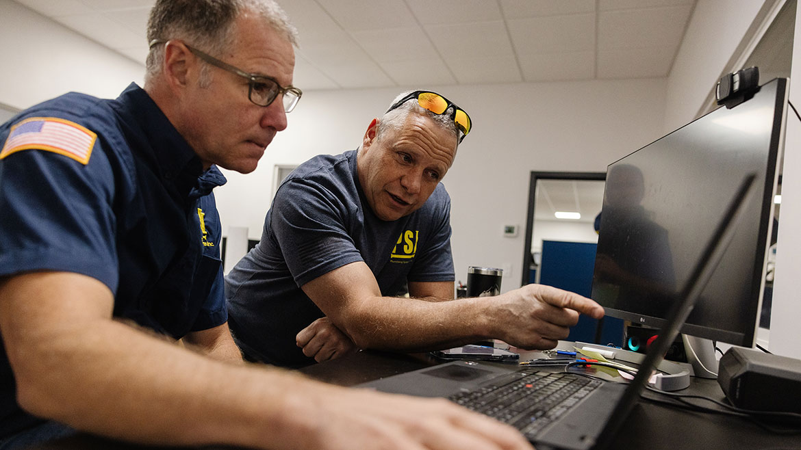 (L-R) Peter Geyer, PSI head of special products, discusses a new CRM program with PSI founder Jim Harper.