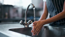 Point-of-use water disinfection feature image of washing hands over the sink