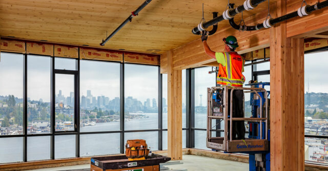 A JH Kelly plumber works on a new shell and core project on North Lake Union in Seattle.