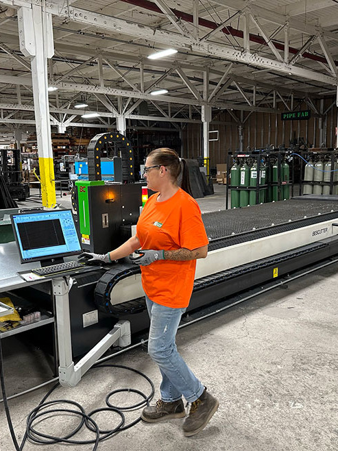 JH Kelly employee working on a computer in the warehouse