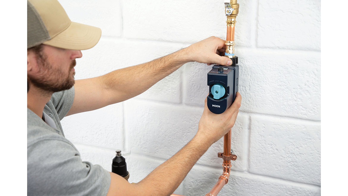 Plumber using a Moen leak detection device.