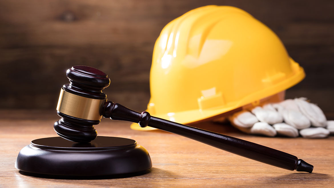 Gavel In Front Of Yellow Safety Helmet