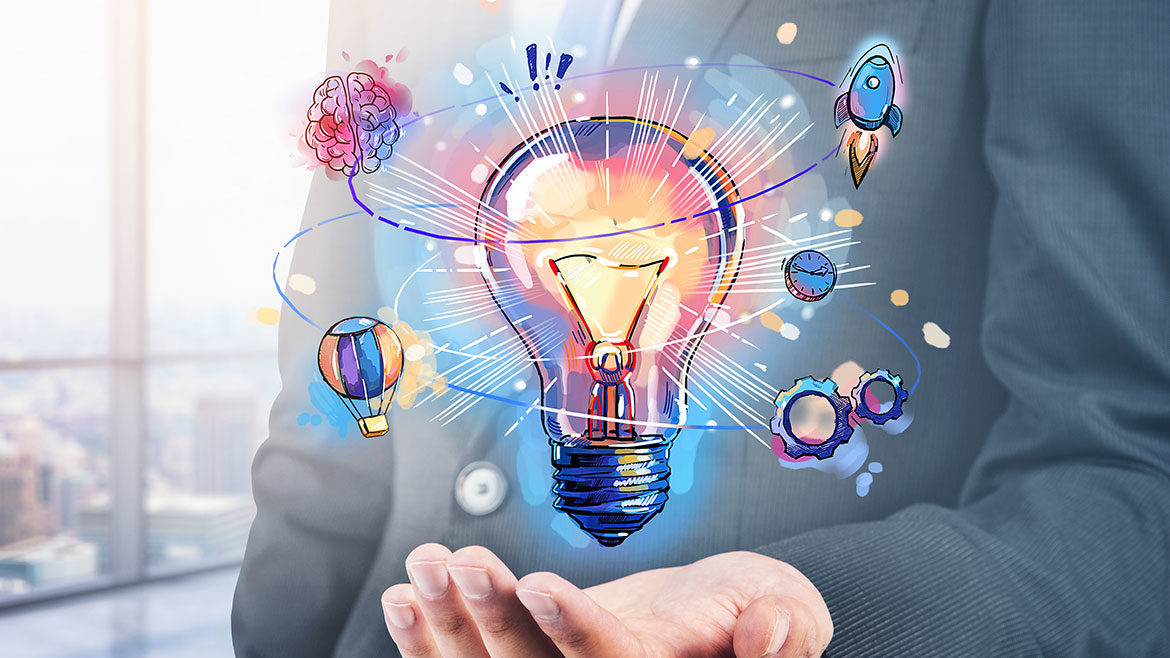 Businessman hand holding hologram of colorful light bulb as a concept of new idea for start up.