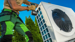 HVAC Technician Installing Large Modern Heat Pump